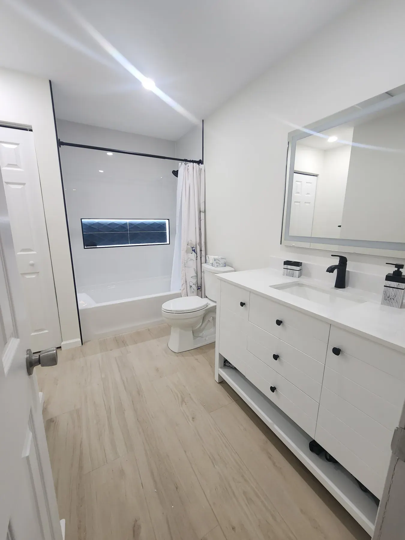 White furniture-style vanity on legs with a stone top